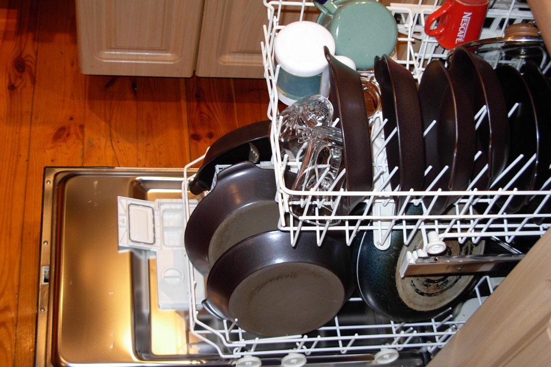 Built-in stainless steel dishwasher installed in a modern kitchen cabinet