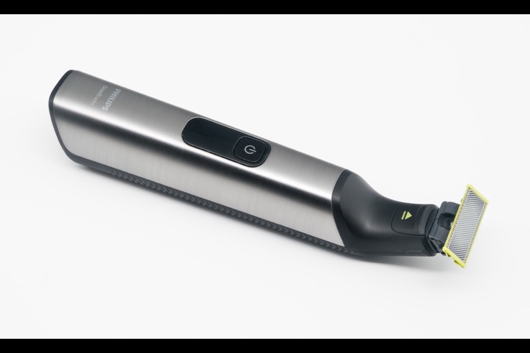 Women's electric foil shaver on a marble bathroom countertop