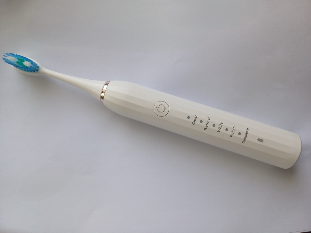 White sonic electric toothbrush with five cleaning mode indicators