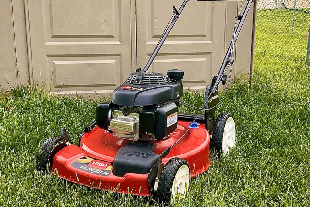 Self-propelled lawn mower cutting a residential front lawn