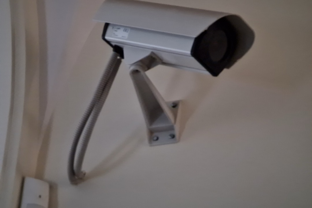 Outdoor security camera mounted on a residential home exterior wall