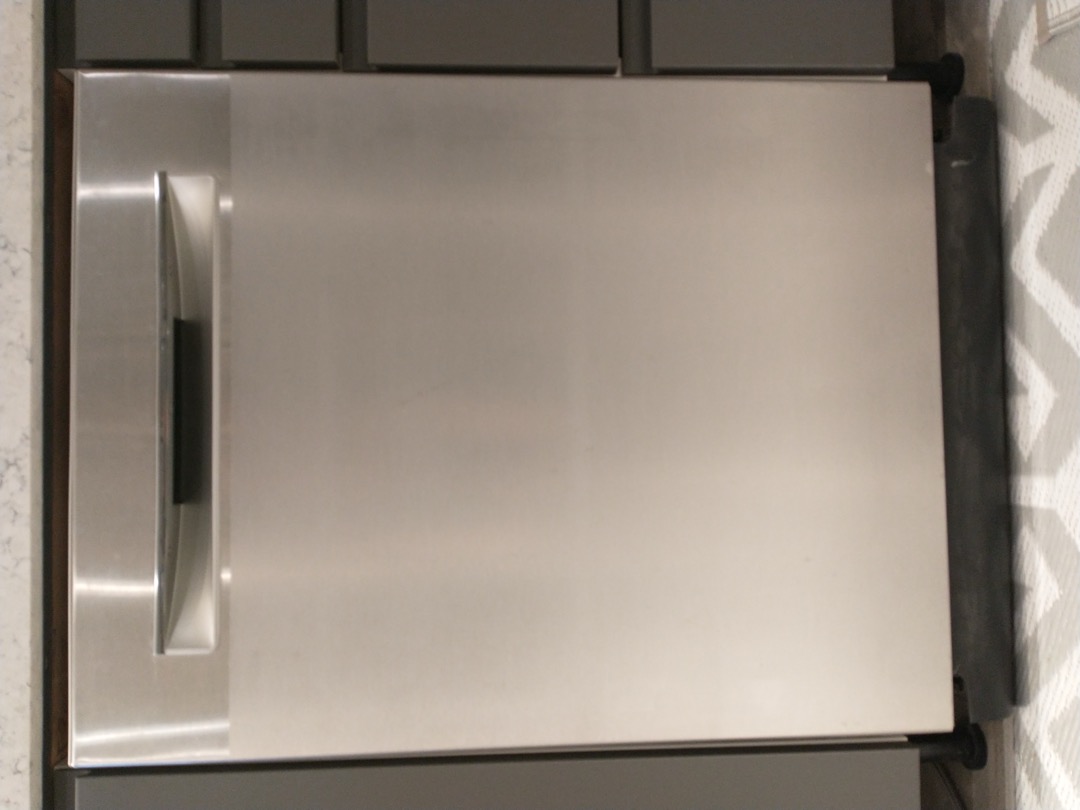 Freestanding stainless steel dishwasher in a kitchen