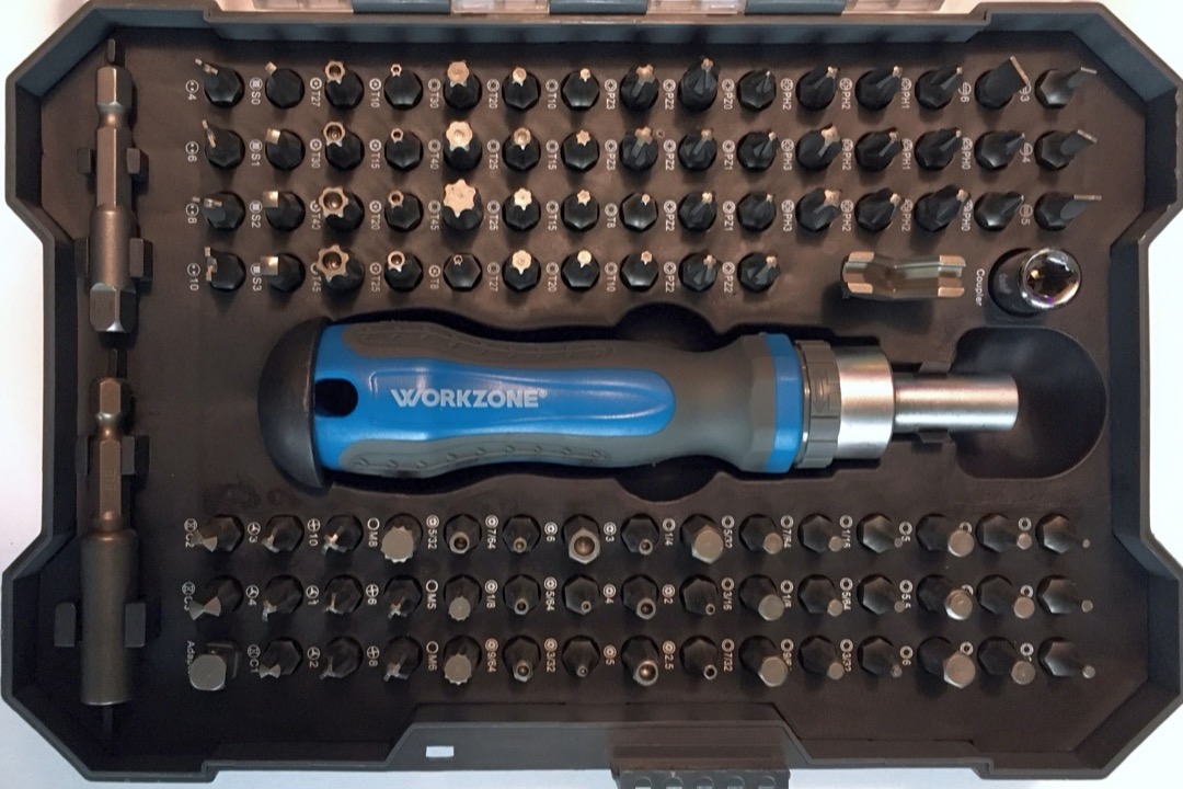 Set of screwdrivers with color-coded handles arranged on a workbench