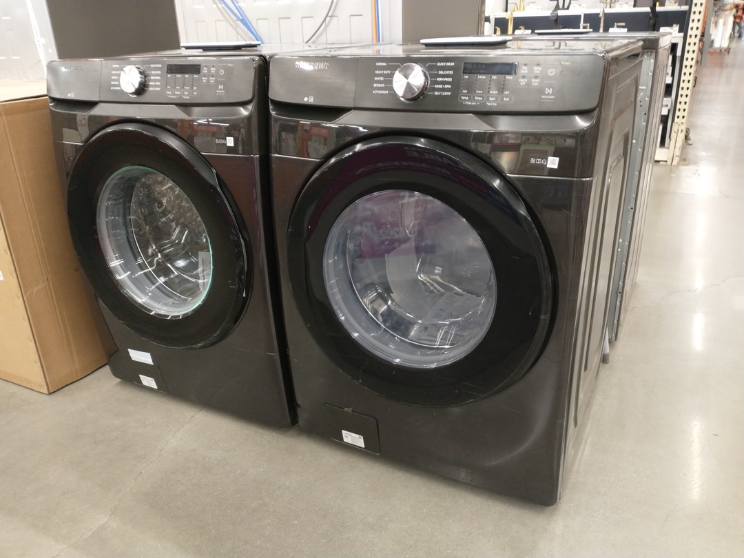 Top load washing machine with open lid showing drum interior