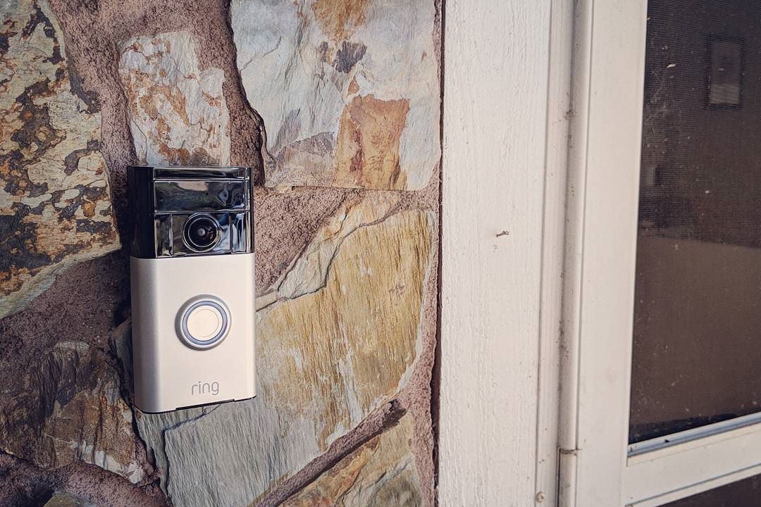 Video doorbell mounted beside a residential front door