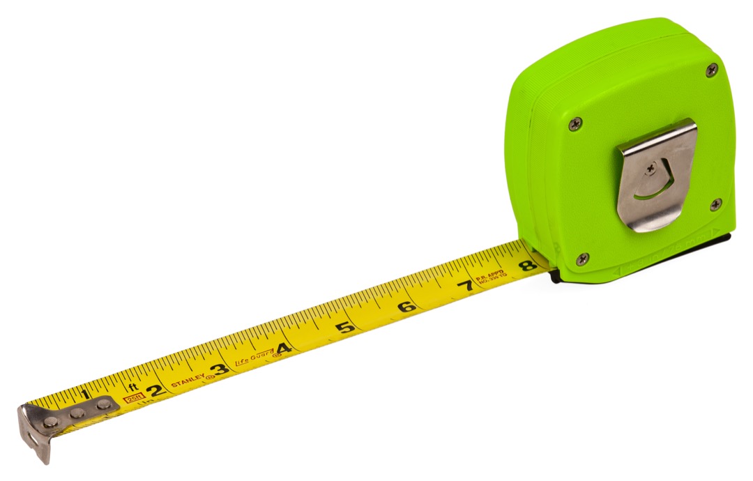 Steel tape measure extended showing inch numbers, fractional tick marks, and the sliding true-zero end hook